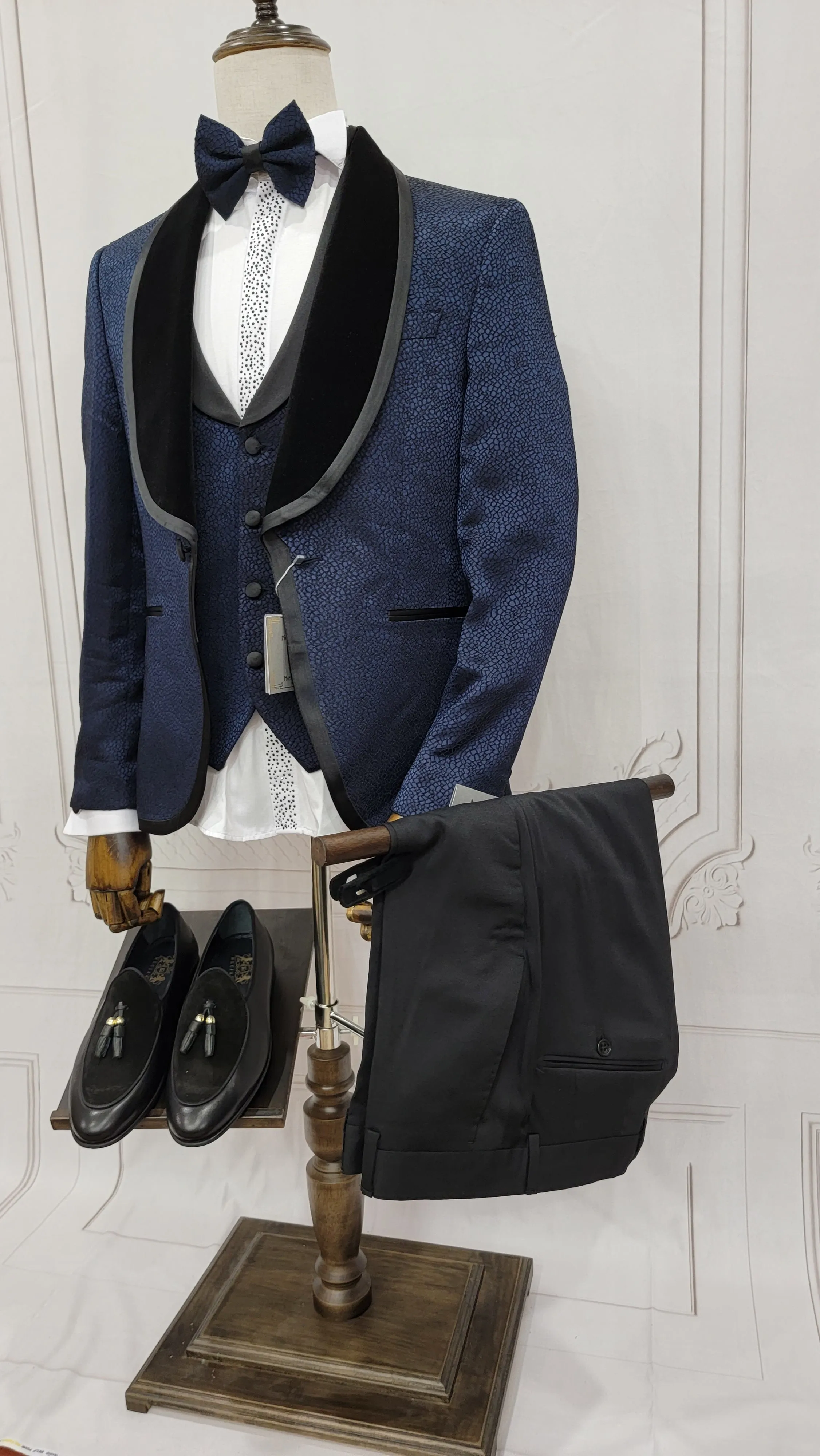 Single button three piece men's Suit with contrasting black velvet lapel, matching bow tie and Black Pants